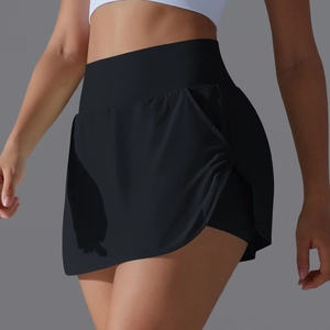 Detail view of high-waisted black tennis skort with side slit and inner shorts