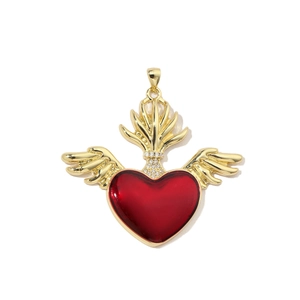 Macro shot of gold winged heart pendant with red enamel and shimmering white rhinestones
