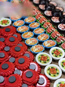 Detailed back view of resin food magnets showing the round magnetic attachment and textures