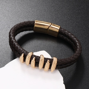 Detail of men's brown braided leather bracelet featuring a gold magnetic clasp on stones