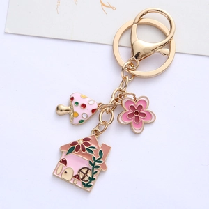 Cute enamel keychain with mushroom, flower and cottage charms in gold finish