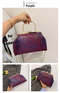 Macro detail of purple vintage frame bag with gold handle and feather-like texture