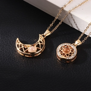 Detail of sun and moon magnetic necklaces with hollow designs and inset crystal stones