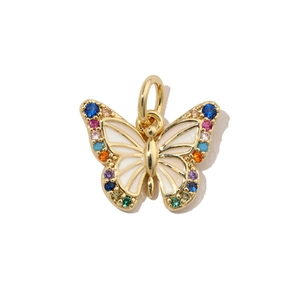 Detailed close-up of a golden butterfly pendant with colorful zircon and white enamel
