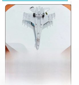 Detail view of the gray fighter jet model featuring its black pull-back motor mechanism