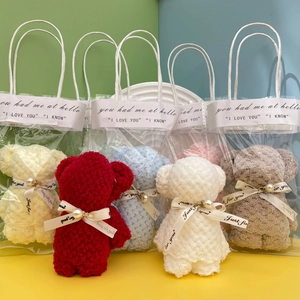 Detail of coral fleece bear towels in multiple colors with gift bags and ribbons