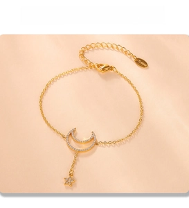 Detail of PVD plated stainless steel bracelet with zircon moon and star charms