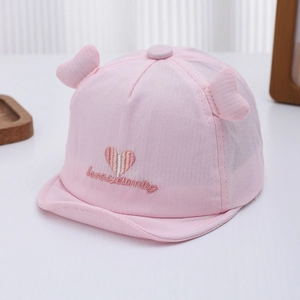 Detail of baby pink sun hat with heart embroidery and cute soft 3D ear decorations