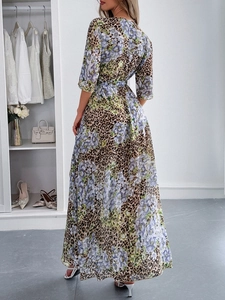 Back view of a long floral leopard print dress with a waist belt and v-neck design