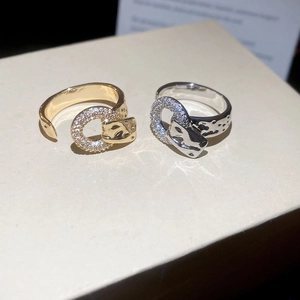 Detailed macro view of gold and silver snake rings with sparkling cubic zirconia inlay