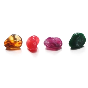 Detailed view of irregular translucent acrylic beads with polished amber texture for DIY jewelry