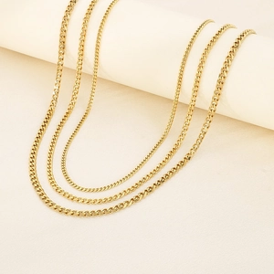 Detailed view of various 18K gold plated stainless steel Cuban link chains on display