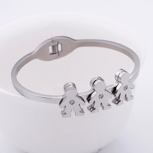 Minimalist silver open bangle with three doll charms featuring sparkling zircons