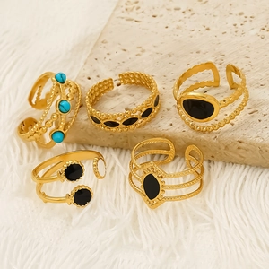 Five gold titanium steel open rings set with turquoise and black enamel inserts