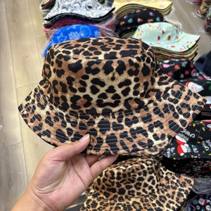 Close-up of the leopard print pattern and fabric texture on a double-sided bucket hat