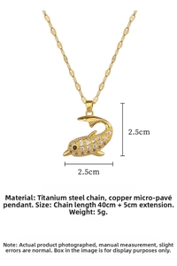 Macro detail of a gold dolphin pendant with micro-pave white and black zircon crystals