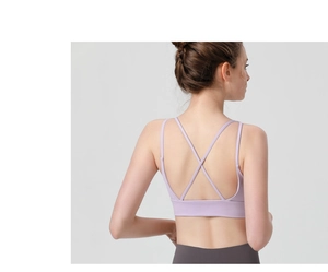 Detail of light purple sports bra featuring cross back straps and high-elastic fabric