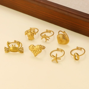 Detailed close-up of 7-piece gold ocean themed rings with crab and starfish designs