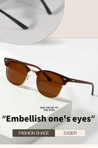 Detail of vintage semi-rimless sunglasses with gold metal bridge and brown acetate frame