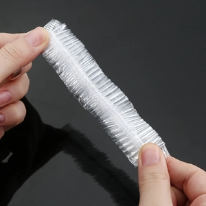 Compressed disposable food grade plastic storage covers held by hands for kitchen use