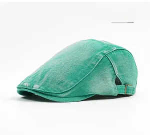 Detail view of grass green cotton newsboy cap with vintage distressed texture and buckle