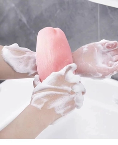Pink foaming mesh net showing rich soap bubbles for facial and body cleansing detail
