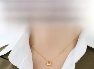 Polished 18K gold-plated oval pendant necklace on a model with business attire