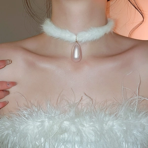 Detail of white plush choker featuring a pink teardrop pearl pendant on a model neck