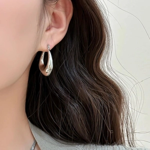 Polished silver geometric teardrop earrings for women in a minimalist metal C-shape style