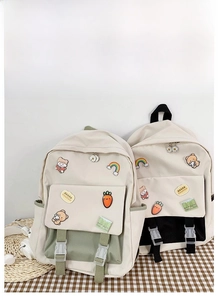 Detail of Korean style school backpack with DIY cartoon badges and large capacity storage