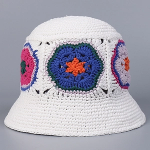 Detailed close-up of handmade white crochet bucket hat with vibrant floral knit patterns