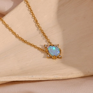 Detailed view of water drop opal pendant with diamonds on a gold chain necklace