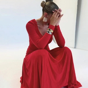 Detailed close-up showing V-neck design and draped red fabric texture of the long dress