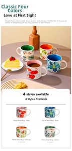 Close-up of ceramic mugs with floral patterns, large handles and colored inner walls