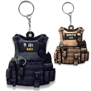 Detailed close-up of tactical vest acrylic keychains in navy blue and desert tan colors