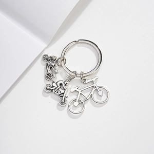 Detailed view of silver metal keychain featuring motorcycle and bicycle pendants