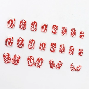 Short square press-on nails with minimalist red swirl design on white glossy finish