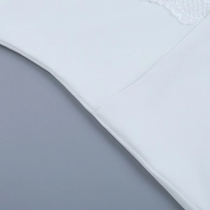 Close-up of white yoga jumpsuit showing premium lace edges and detailed stitching textures