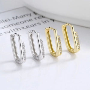 Close-up of S925 sterling silver U-shaped hoop earrings with sparkling paved zircons