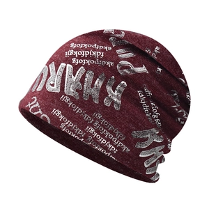Detailed knit texture and silver letter print on a dark red winter beanie hat