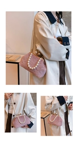 Pink faux fur shell bag with elegant pearl strap and gold-tone metal frame clasp detail