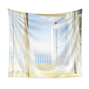 Detail of bohemian tapestry featuring a balcony view with white curtains and blue ocean scenery