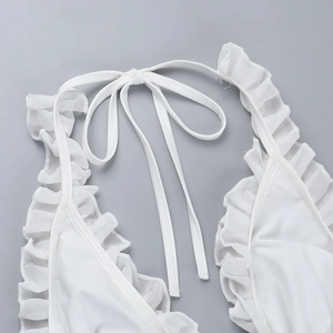 Detailed view of white ruffle halter neckline and tie straps on bikini swimsuit top