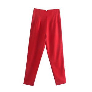 Detailed flat lay view of red high-waisted tapered trousers for women with a minimalist cut