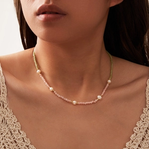 Natural peridot and pink opal beaded necklace with freshwater pearls on a model