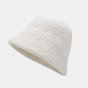 Detail of soft cream wool blend bucket hat featuring a plush textured faux fur finish