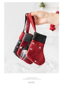 Close-up of three wool felt Christmas stockings with snowflake and gnome details
