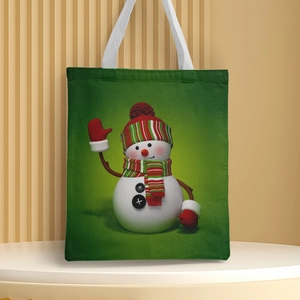 Close-up of a green canvas tote bag featuring a cute snowman holiday print