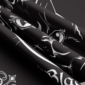 Close-up of bohemian cat tapestry fabric with detailed black and white feline eye print