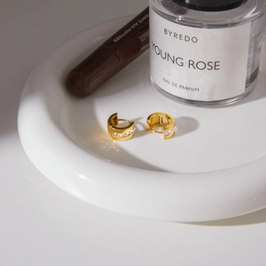 Luxurious gold stainless steel hoop earrings with square cubic zirconia in ceramic tray